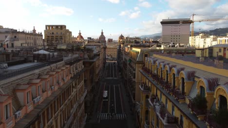 drone shot of street and plaza in genoa city center with lofty houses