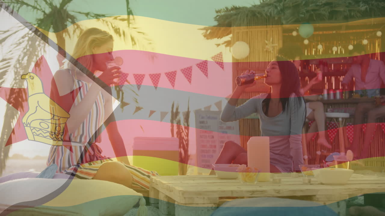 Women enjoying drinks at beach bar over Zimbabwe flag animation