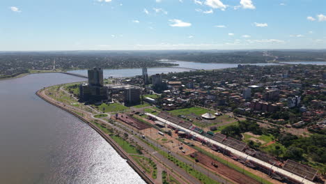 panorama drone view of the encarnación city waterfront greenery and residential district, itapúa, paraguay