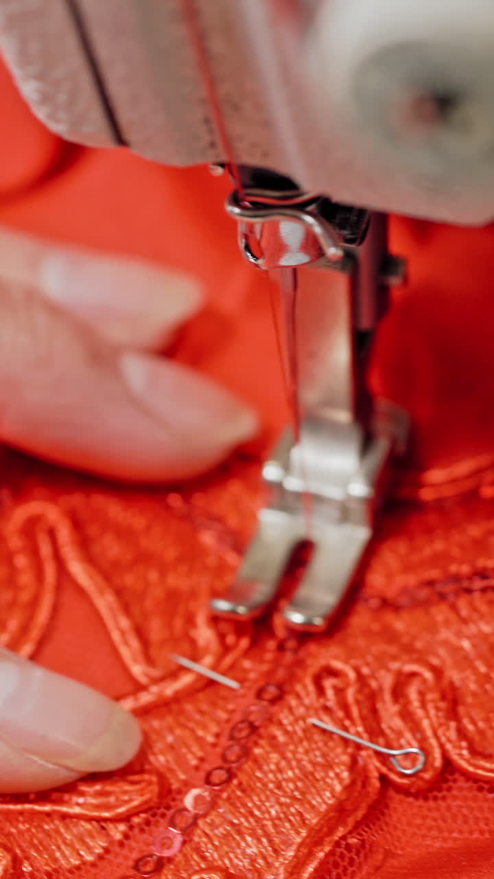 Woman sews clothes on sewing machine. Woman hands drawing pattern on fabric with sewing machine Vertical video