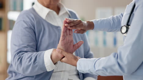 doctor examining patient's hand