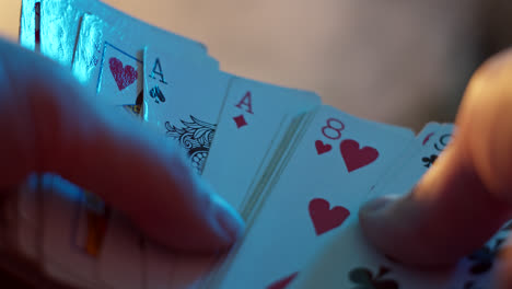 close-up of hands shuffling playing cards