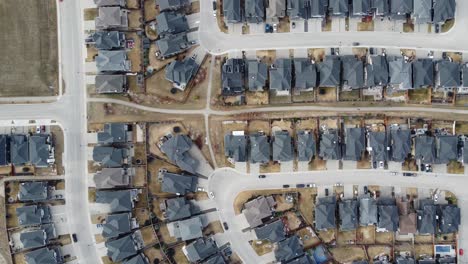 Aerial-view-of-a-modern-suburban-community-in-Calgary,-Canada,-in-spring-after-the-snow-melt