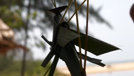 thai traditional woven decoration made from banana leaf blows in the breeze