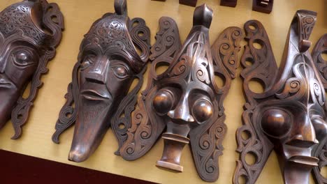 carved traditional batak masks displayed at lake toba, samosir island