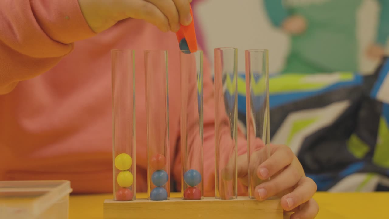 Dropping a plastic ball into a test tube