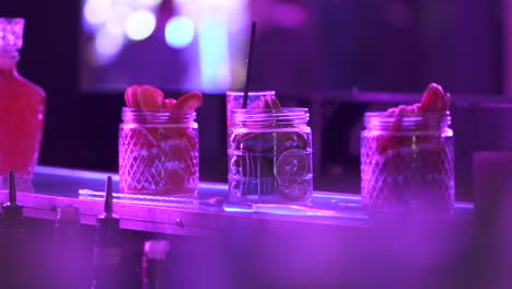 cocktail garnish, orange slices and lime inside nightclub bar area