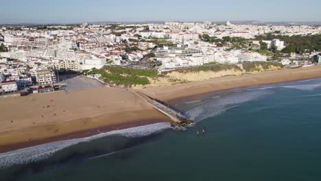 albufeira beachfront and whitewashed cityscape, algarve portugal aerial panoramic