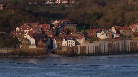 establishing drone shot of robin hood's bay and landscape sunny morning