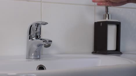 washing female hands throughly with soap, medium shot