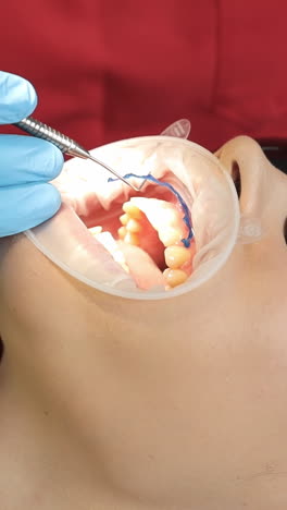 close-up shot of dentist in uniform looking at dental operating microscope hi-res. doctor using medical equipment. medicine and healthcare concept