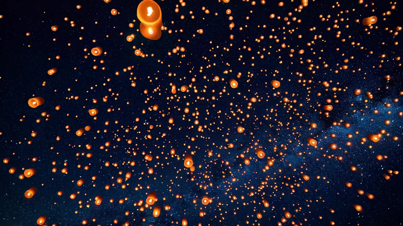 Migliaia di lanterne celesti luminose che si innalzano nella notte stellata
