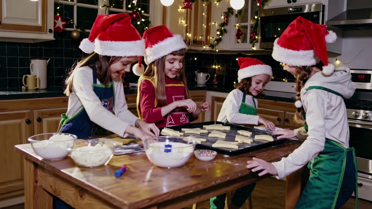 Festive kitchen scene with children in Santa hats baking cookies