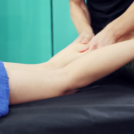 close-up woman's legs and masseur's hands doing medical treatment. a man therapist does foot massage for girl. spa centre concept