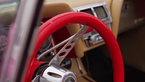 classic car interior with red steering wheel