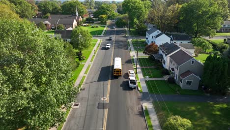 yellow school bus driving on small town usa street