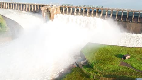 Reservoir-releasing-water-into-a-river,-flooding-Vaaldam-South-Africa,-Drone-Shot