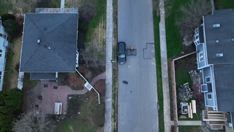 cyclist rides bike at night on residential street