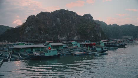 Aerial-panning-shot-of-boats-parked-at-Lan-Ha-Bay-during-sunset