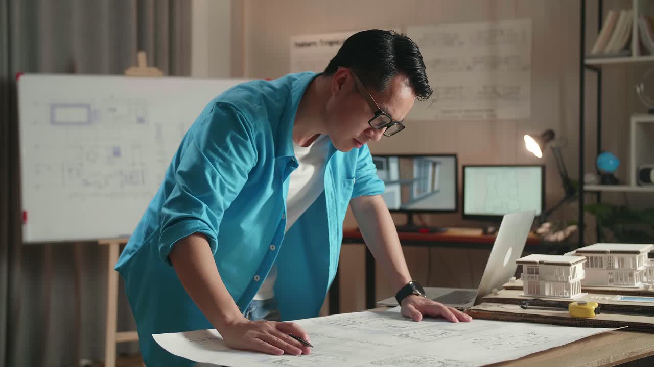Architect Working on House Plans at Night