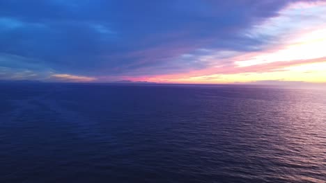 Purple sunset as the sun drops below the horizon  in Menorca Spain