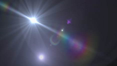 mancha de luz y destello de la lente contra un fondo negro
