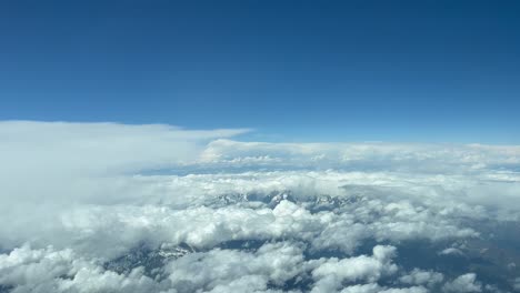 cumulus clouds against blue sky over mountain range