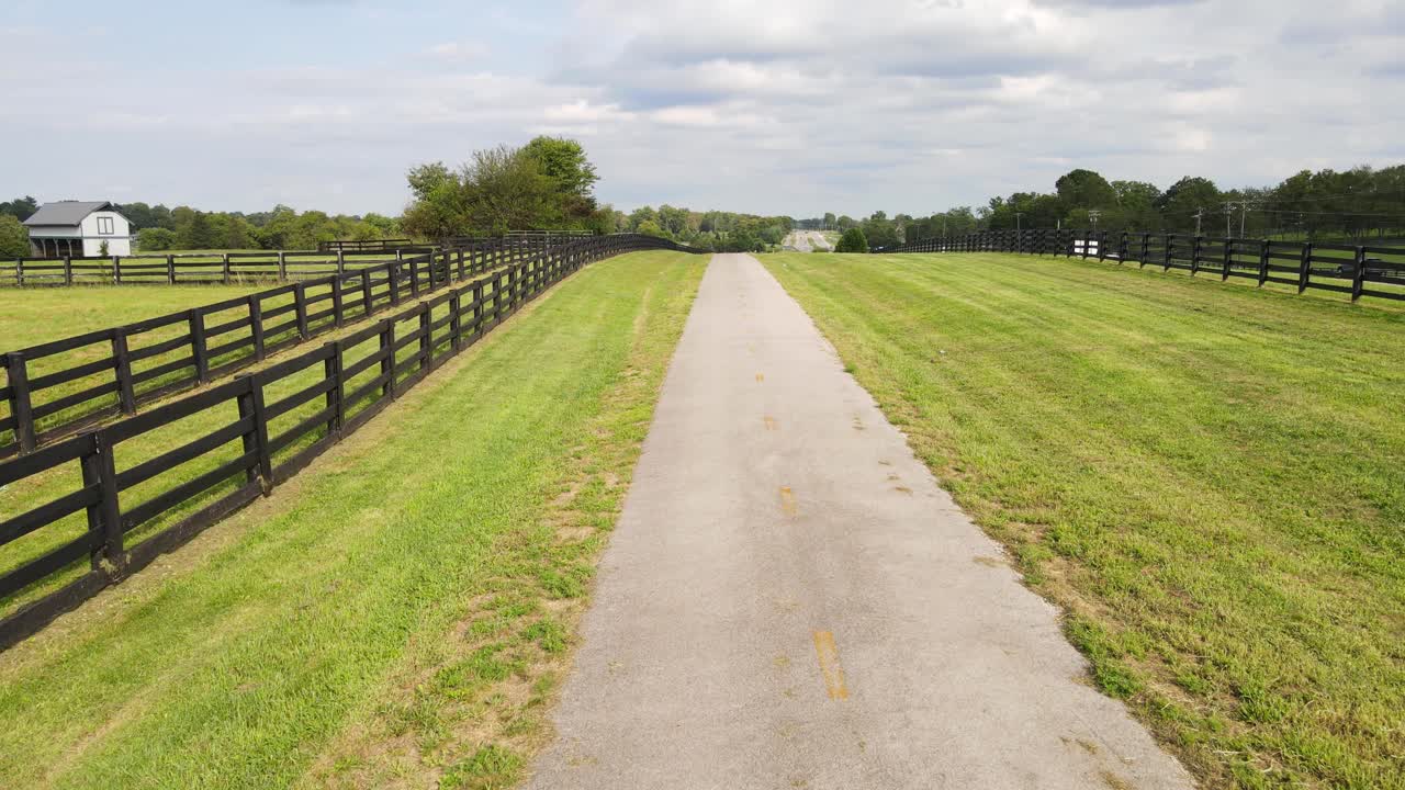 Empty rural road with wooden fences in Kentucky Horse Park in Lexington Kentucky, USA