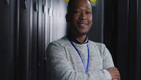African-american-male-computer-technician-with-security-pass-in-business-server-room
