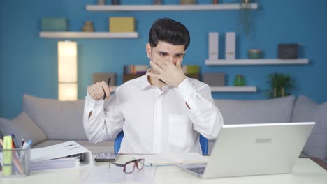 young business man working in home office working tired and exhausted.