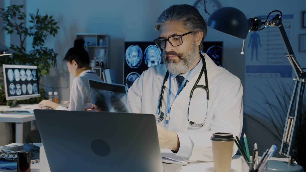 Doctor Reviewing X-rays at Night