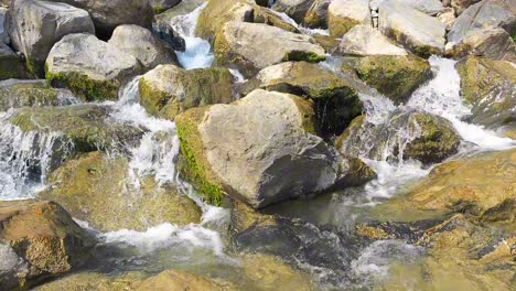 water cascades over rocks and stones in the river at weesen, glarus, switzerland, revealing nature's beauty