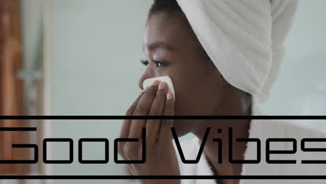 animación de buenas vibraciones texto sobre mujer afroamericana limpiando la cara en el baño