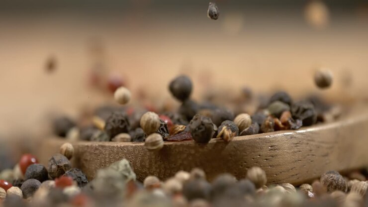 Mixed peppercorns in a super slow motion. Dry mix peppercorns close up.