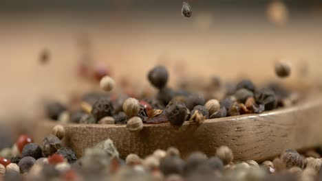 mixed peppercorns in a super slow motion. dry mix peppercorns close up.