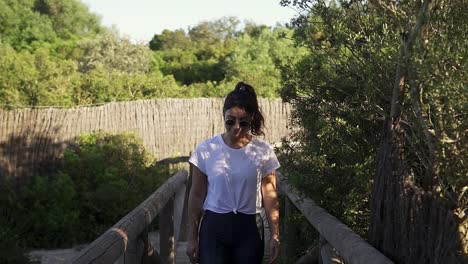 front on shot of a stunning young female model walking along a pathway