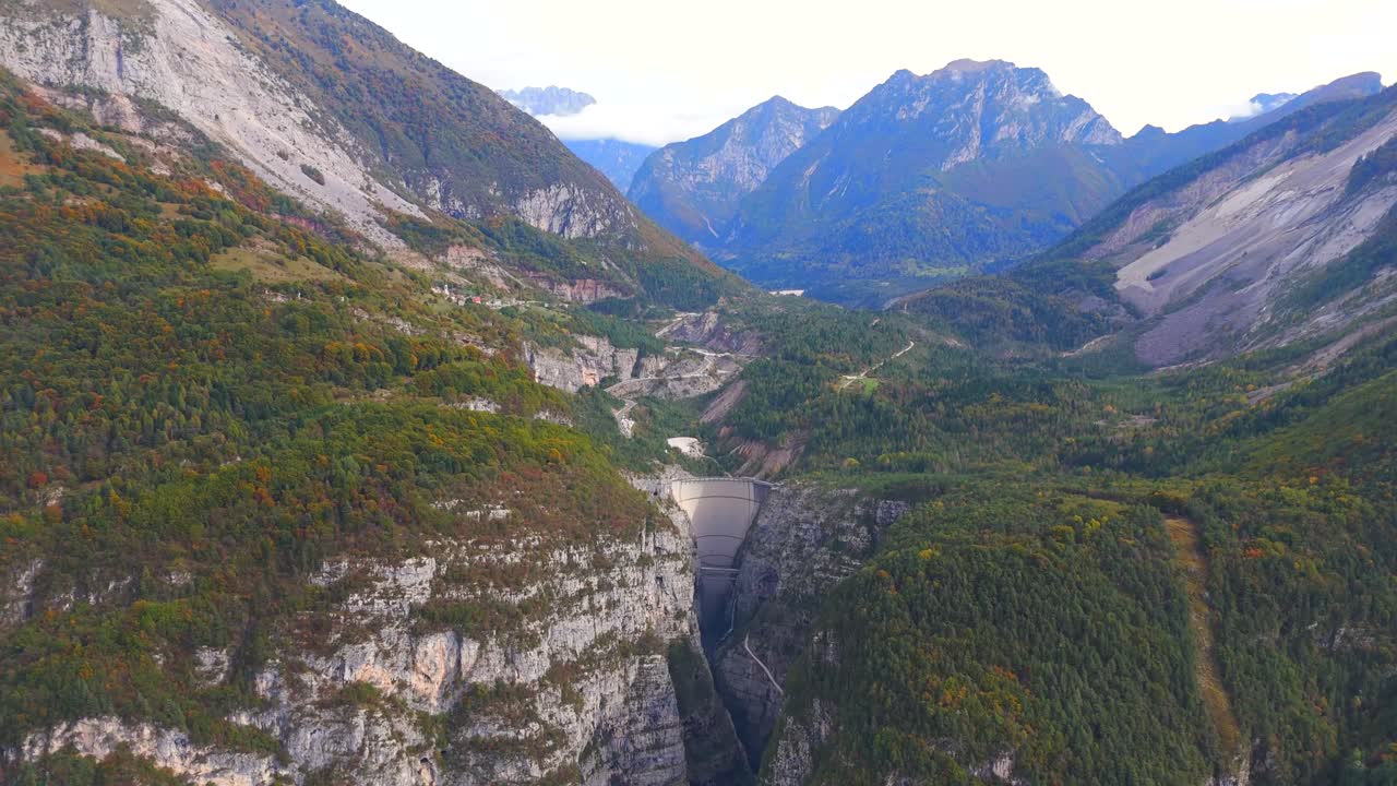 Fly high above the Vajont Dam and its serene reservoir in the Dolomites.