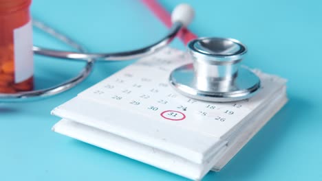 medical calendar with stethoscope and pills