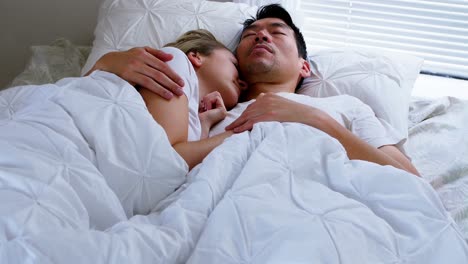 Couple-sleeping-on-bed