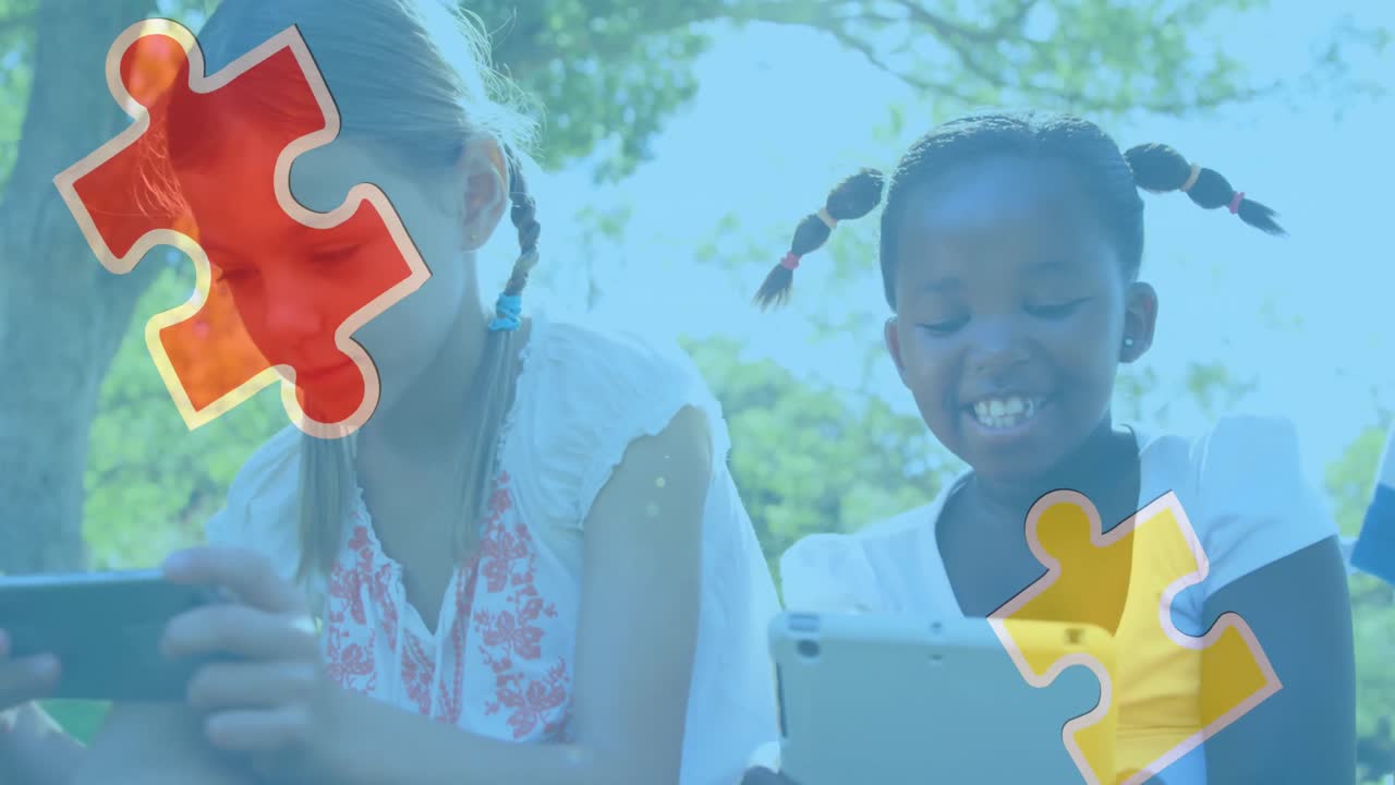 Animation of colourful puzzle pieces over girls using tablets