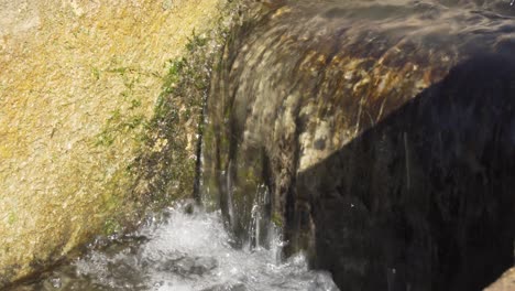 Close-view-of-the-water-of-an-old-arabic-aqueduct-in-Spain-