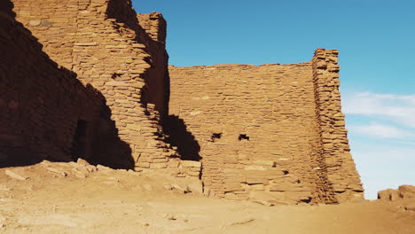 panning view of exterior of ruins at wukoki pueblo on beautiful day