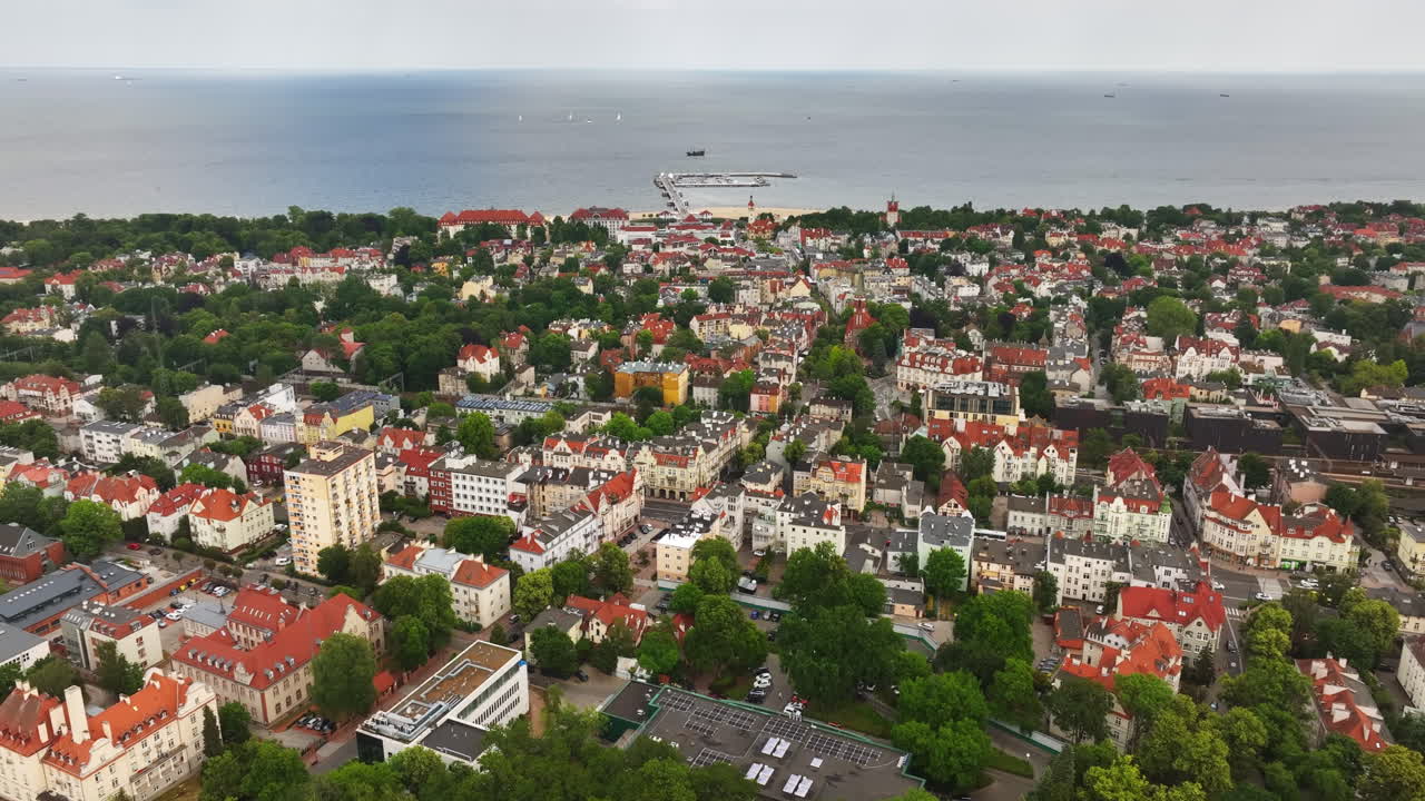 Panoramic drone shot circling the cityscape of Sopot city, summer day in Poland
