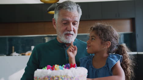 Granddaughter-Celebrates-Birthday-With-Grandfather-By-Putting-Cake-Cream-On-His-Nose-And-Laughing