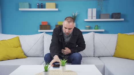 the man who is cold at home. he's making a phone call.