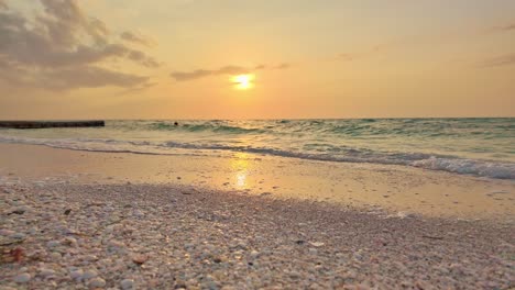 golden hour at punta cocos beach in holbox, mexico with calm ocean waves
