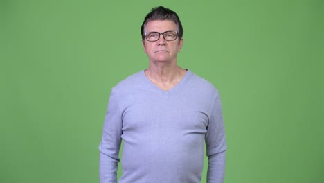 senior handsome man with arms crossed