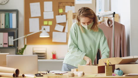 woman packing an order from home