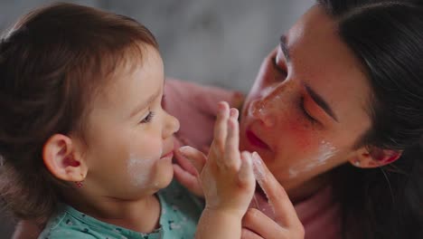 joyful moments: a heartwarming interaction between a mother and her young daughter as they laugh and play together, creating cherished memories in their cozy home environment