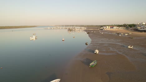 fishing boats during low tide at dawn